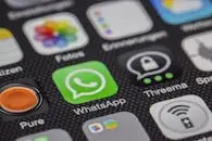 Detailed macro of smartphone screen showcasing popular app icons like WhatsApp.